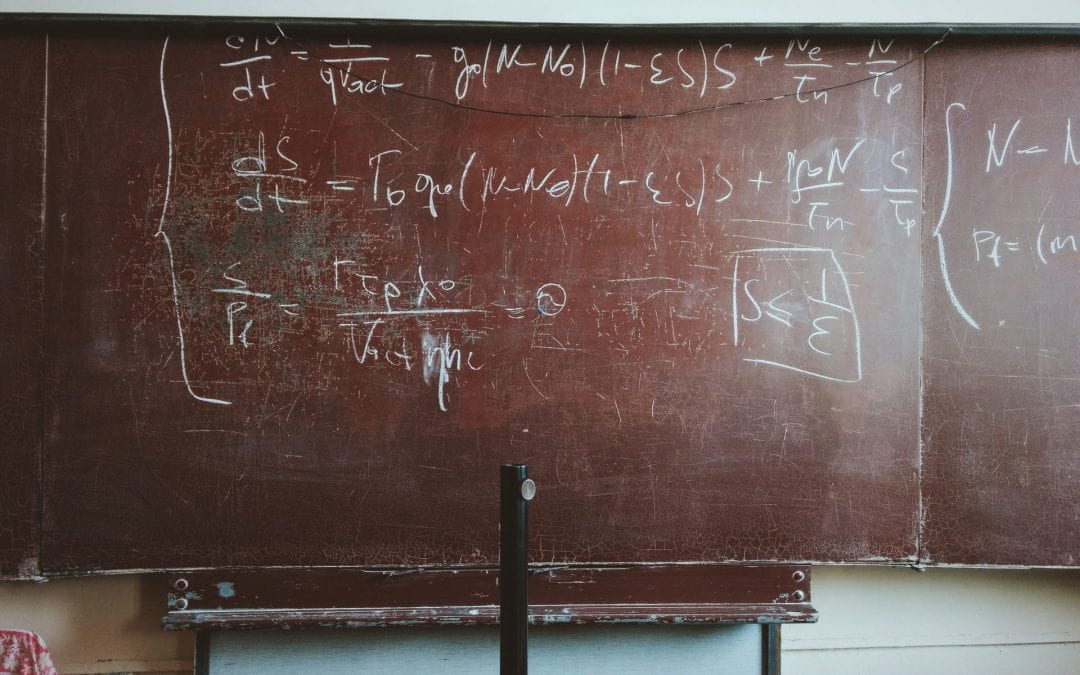Mathematical symbols on an old, red chaclkboard