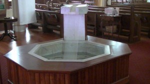 (After) The baptismal fountain is less elegant then what it used to be but is more modern and is also used to get holy water