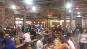 People eat at family-style tables in Krog Street Market