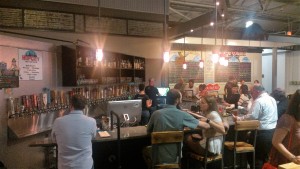 People drinking at a bar inside Krog Street Market