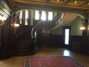The Grand stair-case with the painted glass windows behind it.
