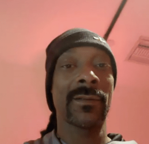 Rapper Snoop Dogg, a Black man with a goatee, wearing a black knit cap