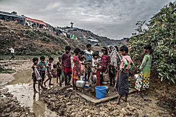 Rohingya obtaining water from a pump at a refugee camp in Bangaladesh