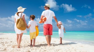 Back view of a happy family on tropical beach; Shutterstock ID 152536469; PO: today-daivd